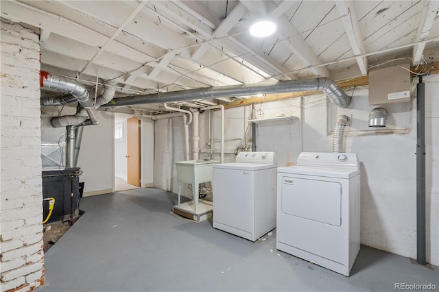 basement with washing machine and dryer and sink