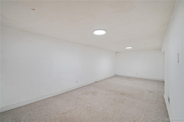 unfurnished room with light carpet