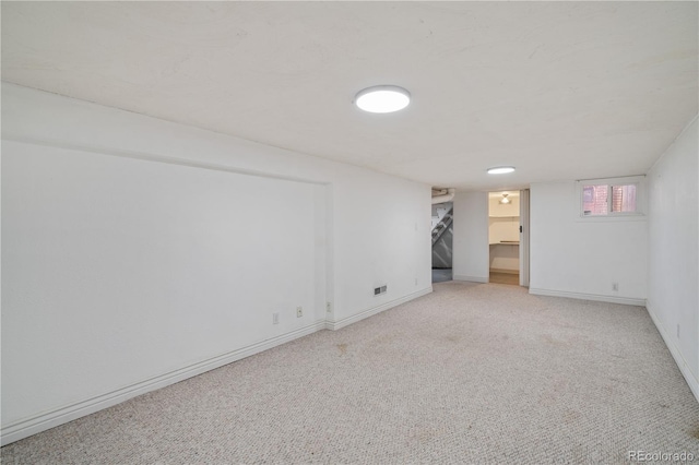 basement featuring light carpet