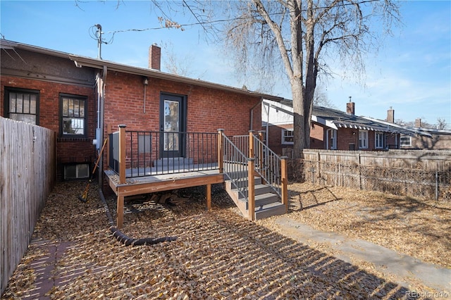 back of house featuring a wooden deck