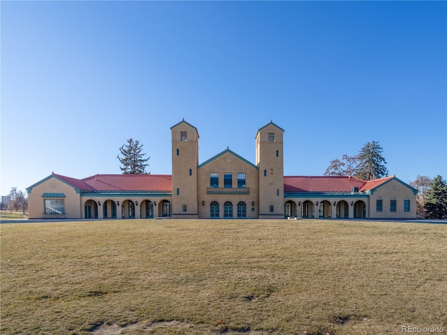 rear view of property featuring a lawn