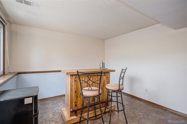 16724 E Hialeah Ave, Centennial, CO 80015 - indoor bar featuring a textured ceiling and stone finish flooring
