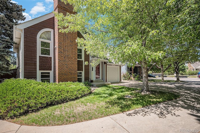 16724 E Hialeah Ave, Centennial, CO 80015 - view of front facade featuring concrete driveway, a garage, and a chimney