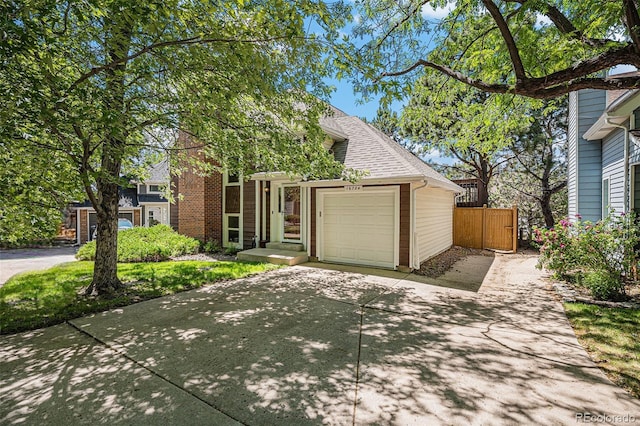 16724 E Hialeah Ave, Centennial, CO 80015 - view of front facade with concrete driveway, an attached garage, and roof with shingles
