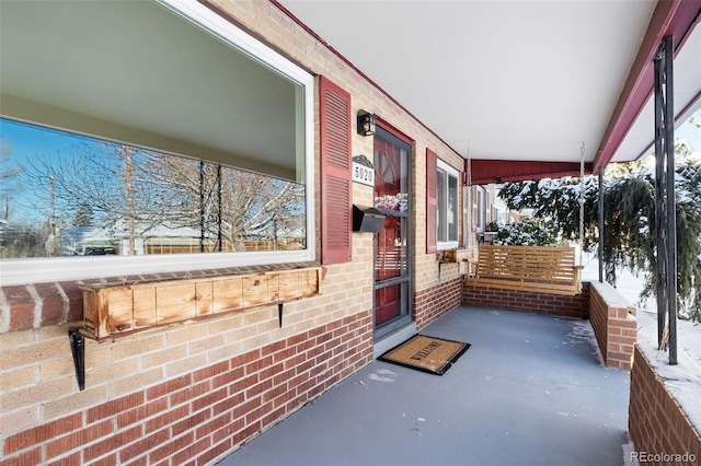 snow covered patio with covered porch