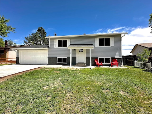 8820 Cody St, Broomfield, CO 80021 - split foyer home with concrete driveway and a garage