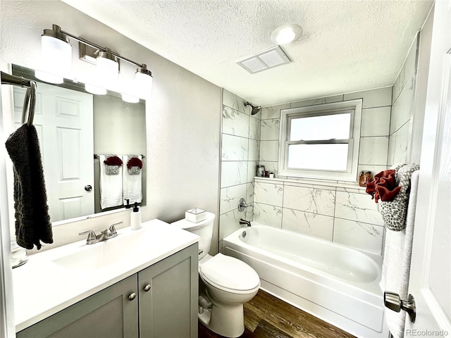 8820 Cody St, Broomfield, CO 80021 - full bathroom featuring a textured ceiling, shower / washtub combination, toilet, wood finished floors, and vanity