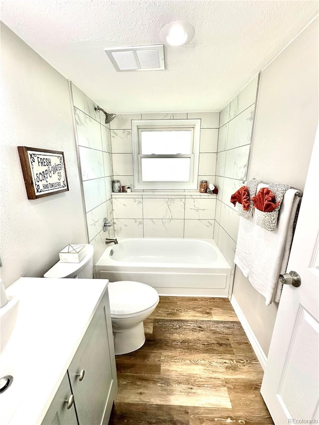 8820 Cody St, Broomfield, CO 80021 - full bathroom featuring a textured ceiling,  shower combination, toilet, vanity, and wood finished floors