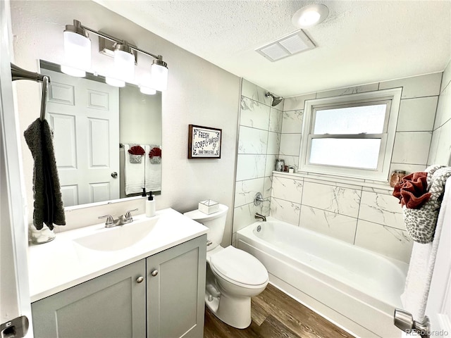 8820 Cody St, Broomfield, CO 80021 - bathroom featuring wood finished floors, a textured ceiling, shower / tub combination, vanity, and toilet