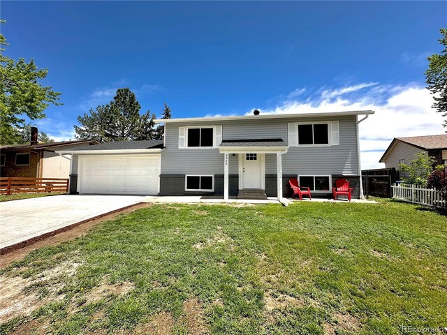 8820 Cody St, Broomfield, CO 80021 - bi-level home featuring concrete driveway, an attached garage, and entry steps