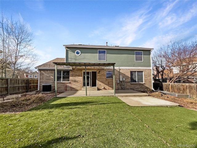 rear view of property with a yard, a patio, and central AC