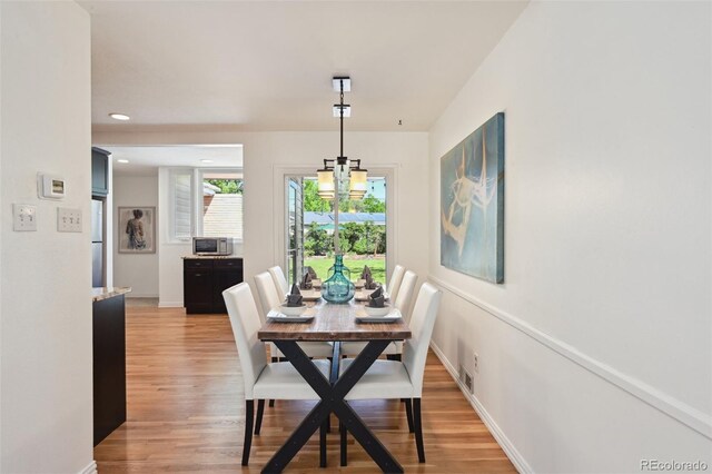 1370 S Hudson St, Denver, CO 80222 - dining area with light wood-style flooring, a chandelier, recessed lighting, and baseboards