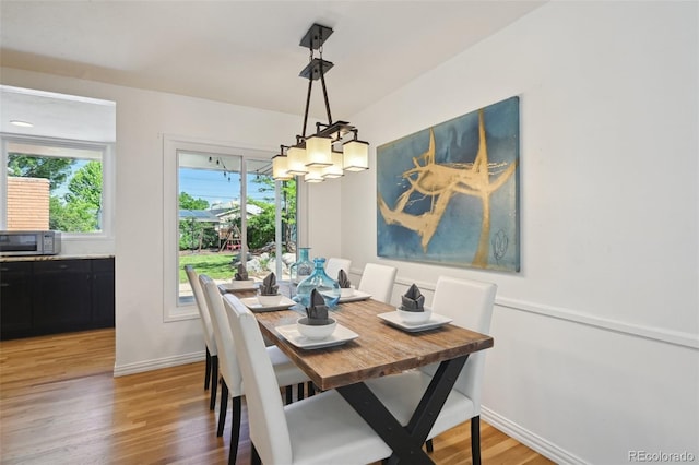 1370 S Hudson St, Denver, CO 80222 - dining area featuring a chandelier, light wood-style flooring, and baseboards