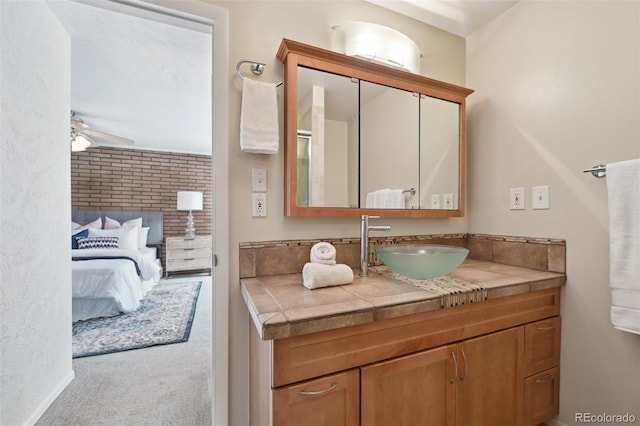 1370 S Hudson St, Denver, CO 80222 - bathroom with vanity, ensuite bath, ceiling fan, and baseboards