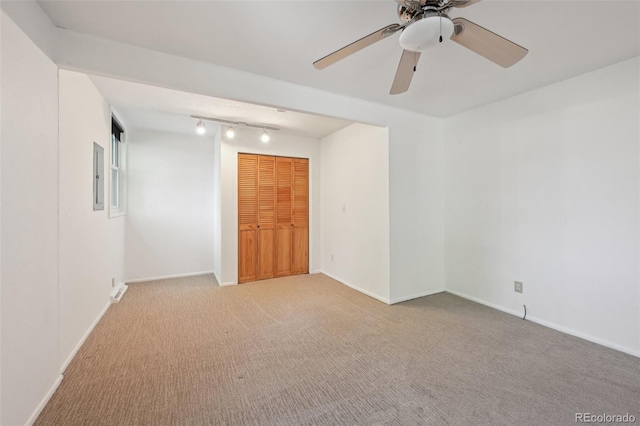 1370 S Hudson St, Denver, CO 80222 - carpeted spare room featuring track lighting, baseboards, and a ceiling fan