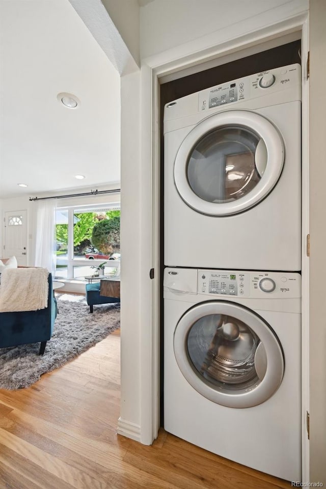 1370 S Hudson St, Denver, CO 80222 - laundry room featuring stacked washer / drying machine and wood finished floors
