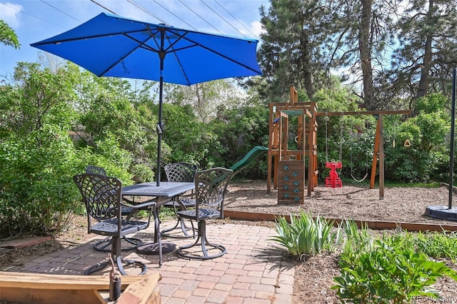 1370 S Hudson St, Denver, CO 80222 - view of patio with a playground and view of wooded area