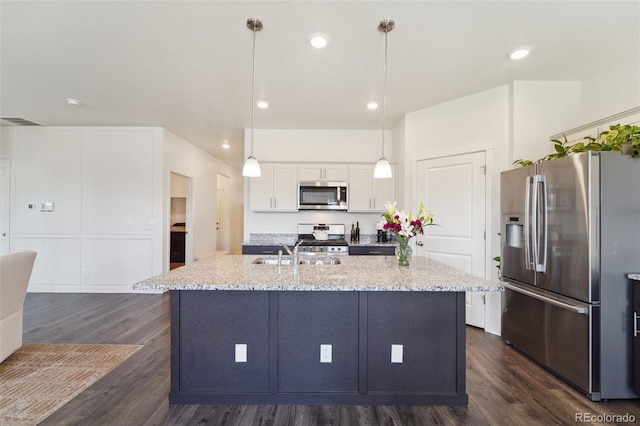 2226 Monte Vista St, Fort Lupton, CO 80621 - kitchen featuring a sink, dark wood finished floors, light stone countertops, and stainless steel appliances
