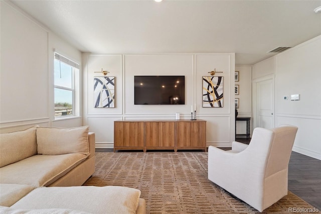 2226 Monte Vista St, Fort Lupton, CO 80621 - living area with visible vents, wood finished floors, and a decorative wall