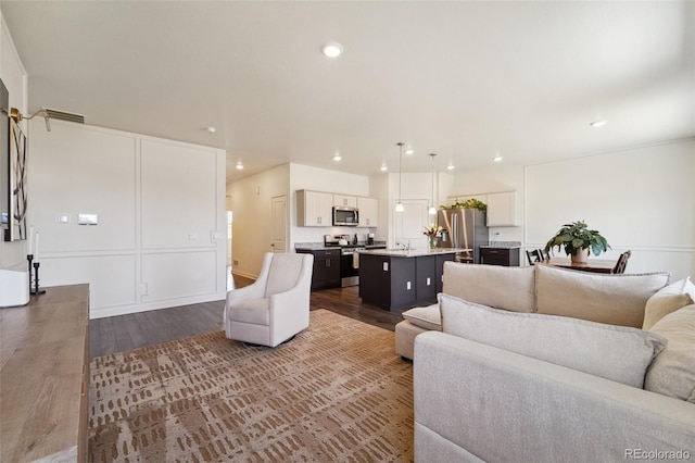 2226 Monte Vista St, Fort Lupton, CO 80621 - living room featuring recessed lighting, dark wood finished floors, and visible vents