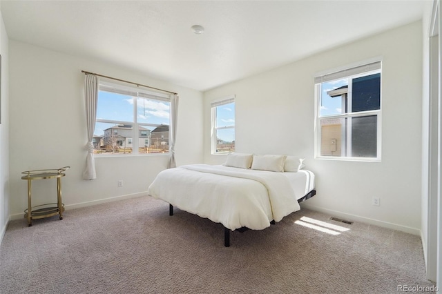2226 Monte Vista St, Fort Lupton, CO 80621 - bedroom featuring visible vents, baseboards, carpet floors, and multiple windows