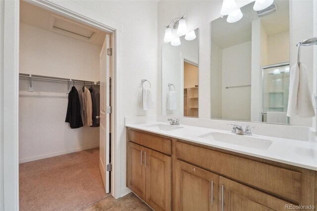 2226 Monte Vista St, Fort Lupton, CO 80621 - bathroom with double vanity, a shower with door, a spacious closet, and a sink