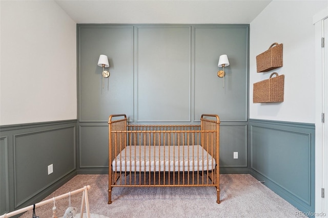 2226 Monte Vista St, Fort Lupton, CO 80621 - bedroom with a nursery area, a wainscoted wall, a decorative wall, and carpet flooring