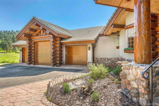 28267 Meadowlark Dr, Golden, CO 80401 - view of front of property with stucco siding, log exterior, and a tiled roof