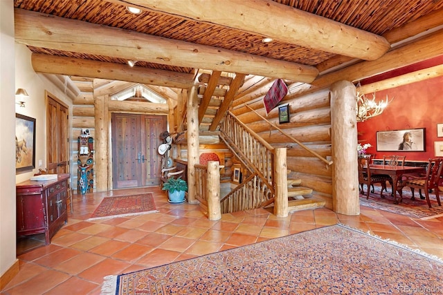 28267 Meadowlark Dr, Golden, CO 80401 - entryway with rustic walls, tile patterned floors, stairway, a wood ceiling with exposed beams, and a chandelier