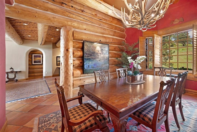 28267 Meadowlark Dr, Golden, CO 80401 - tiled dining room with rustic walls, a chandelier, arched walkways, a wooden ceiling with exposed beams, and recessed lighting