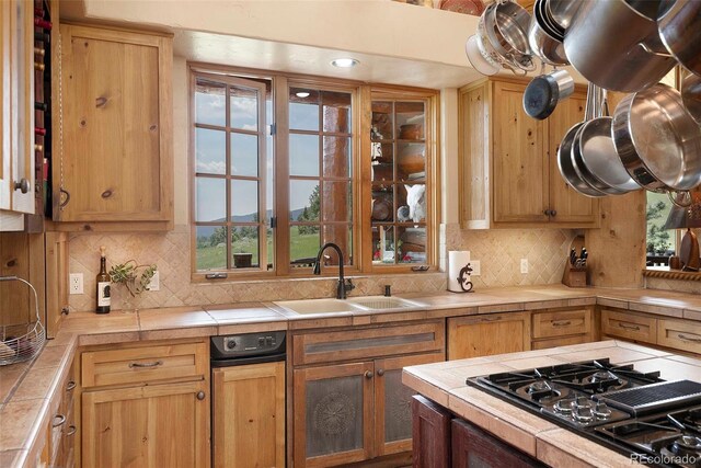 28267 Meadowlark Dr, Golden, CO 80401 - kitchen with tile counters, black gas stovetop, and decorative backsplash