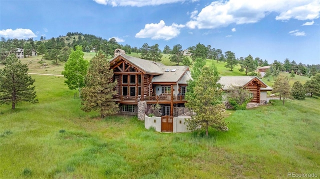 28267 Meadowlark Dr, Golden, CO 80401 - rear view of house featuring log exterior, a chimney, and a deck