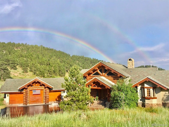 28267 Meadowlark Dr, Golden, CO 80401 - log cabin featuring a chimney, a wooded view, and log exterior