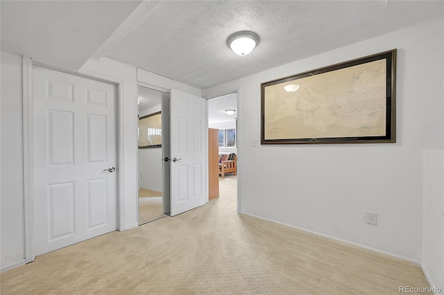 5050 W 102nd Ave, Westminster, CO 80031 - unfurnished bedroom featuring light carpet, baseboards, and a textured ceiling