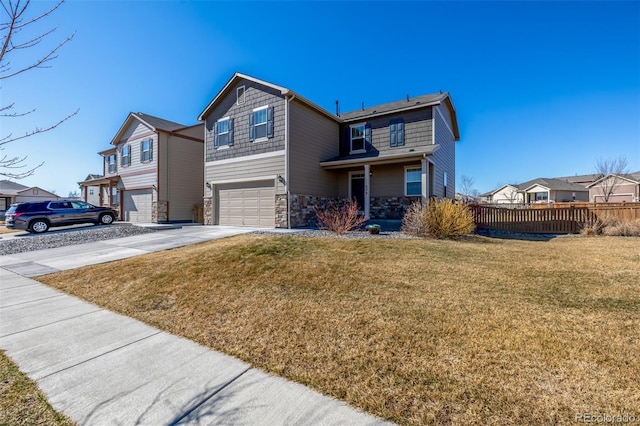 traditional home with driveway, a residential view, an attached garage, fence, and a front yard