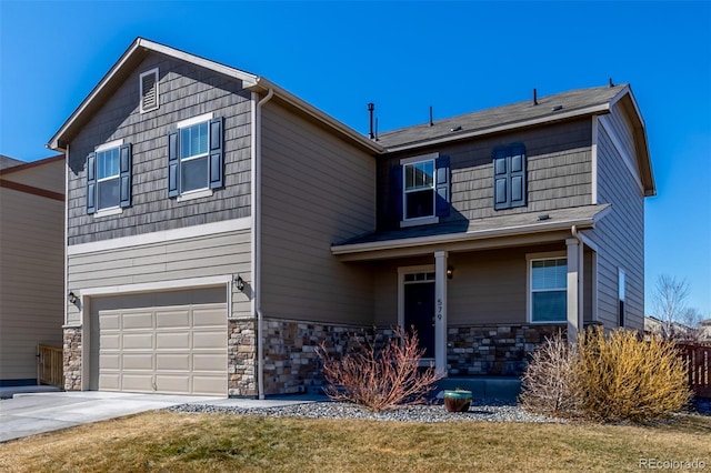 traditional home with stone siding, concrete driveway, and a garage