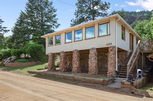 426 Corona Ave, Palmer Lake, CO 80133 - view of front of home featuring stairway and stone siding