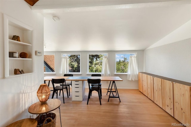 426 Corona Ave, Palmer Lake, CO 80133 - dining area with vaulted ceiling, light wood-style floors, and built in shelves