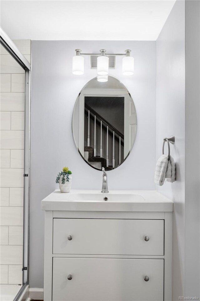 bathroom with vanity and a shower