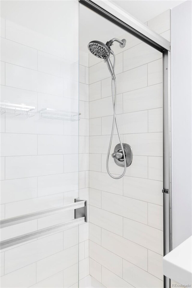 bathroom with tiled shower