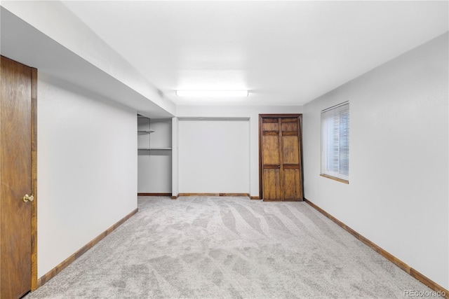 interior space with carpet flooring, baseboards, and a closet