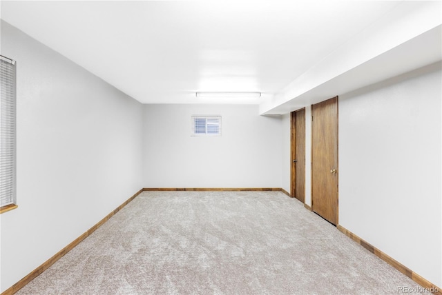 below grade area with baseboards, carpet floors, and visible vents