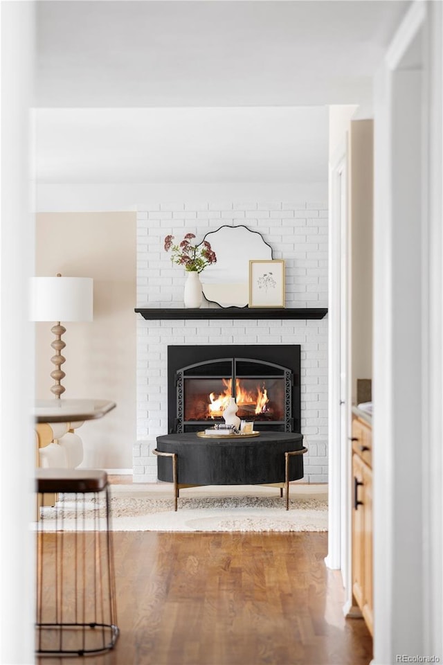 interior details with wood finished floors and a fireplace