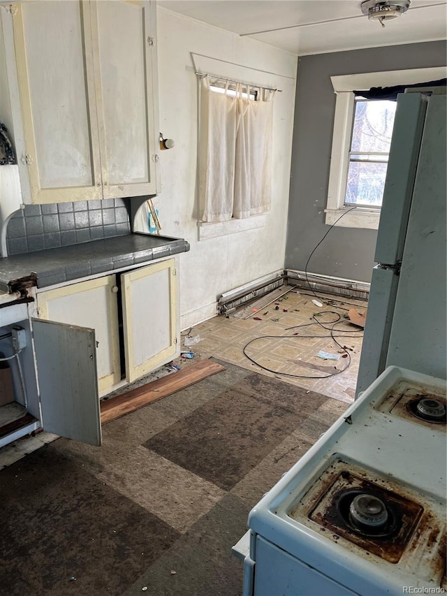 kitchen featuring tile countertops and white appliances