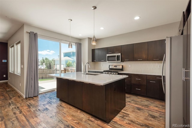 9781 Dunning Cir, Highlands Ranch, CO 80129 - kitchen featuring appliances with stainless steel finishes, dark wood-style flooring, light countertops, dark brown cabinets, and recessed lighting
