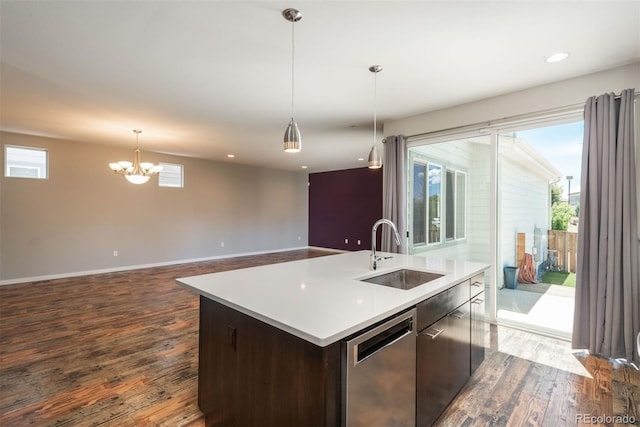 9781 Dunning Cir, Highlands Ranch, CO 80129 - kitchen with stainless steel dishwasher, dark wood-type flooring, an island with sink, healthy amount of natural light, and recessed lighting