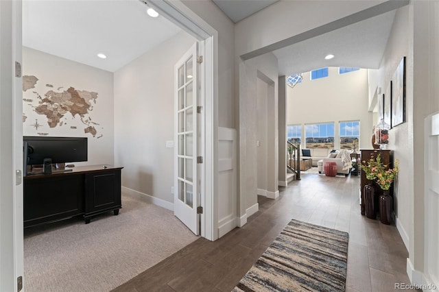interior space with baseboards, recessed lighting, and wood finished floors