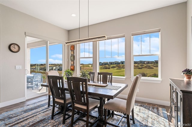 dining space with baseboards, recessed lighting, and dark wood-type flooring