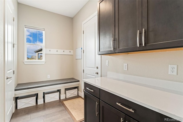 mudroom featuring light wood-style floors and baseboards
