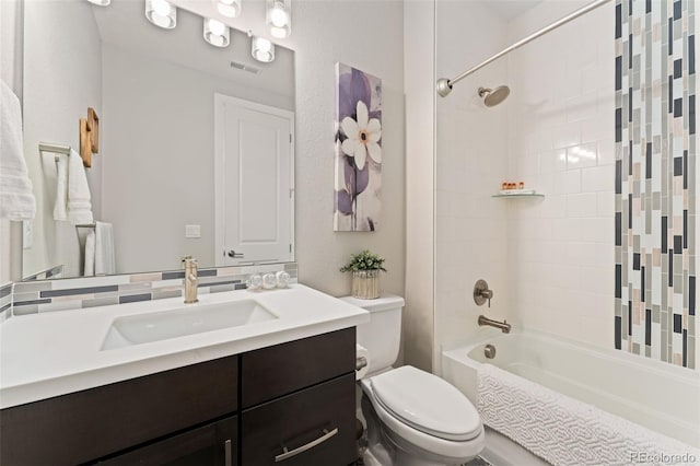 bathroom with visible vents, shower / tub combination, toilet, and vanity